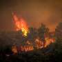 Thousands flee Greek island fires as southern US swelters