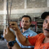 A father and son duo fight invasive lionfish on a Honduran reef