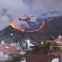 Wildfire sparks panicked evacuations in Los Angeles suburb